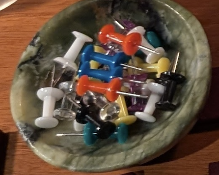 cup of colored push pins